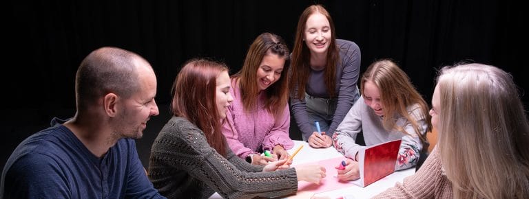 People around the table are planning together.