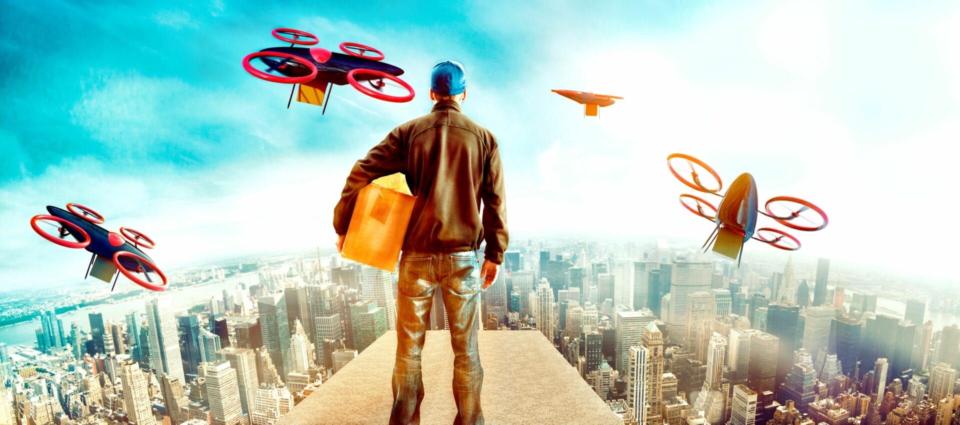 A person stands above the city holding a box while drones fly around them, also holding boxes.