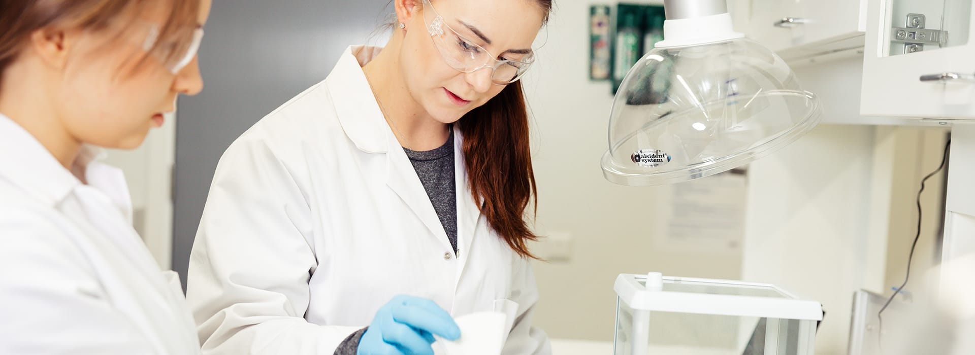 Two female students working in a laboratory.