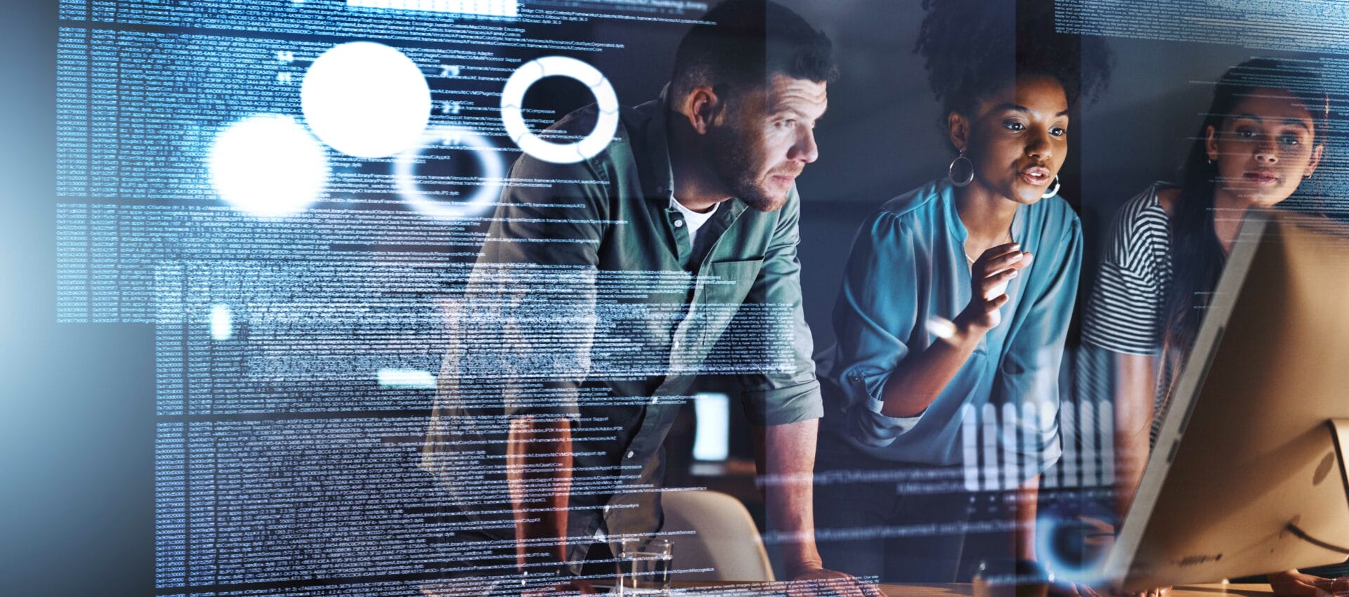 Three people in front of a computer