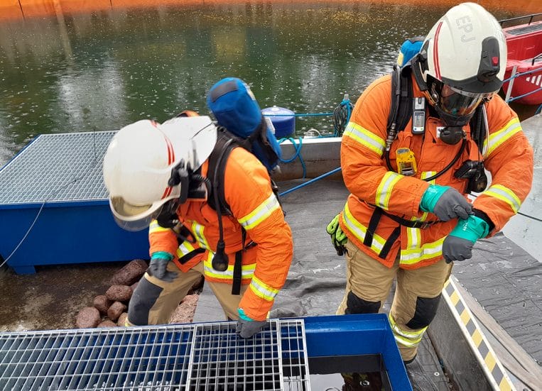 Two men testing oil.