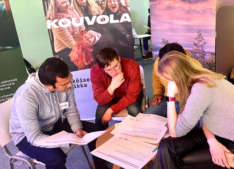 Group of international students around a table.