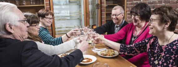 Elderly people eating together.